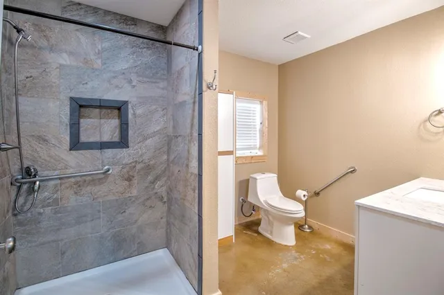 a bathroom with a toilet and a shower