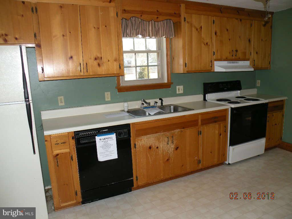 2744 Buckner Road Bumpass, VA 23024 - Photo 8 of 10 a kitchen with stainless steel appliances granite countertop a sink stove and refrigerator