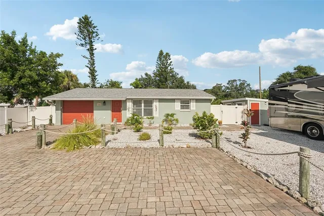 a view of a house with backyard sitting area and garden