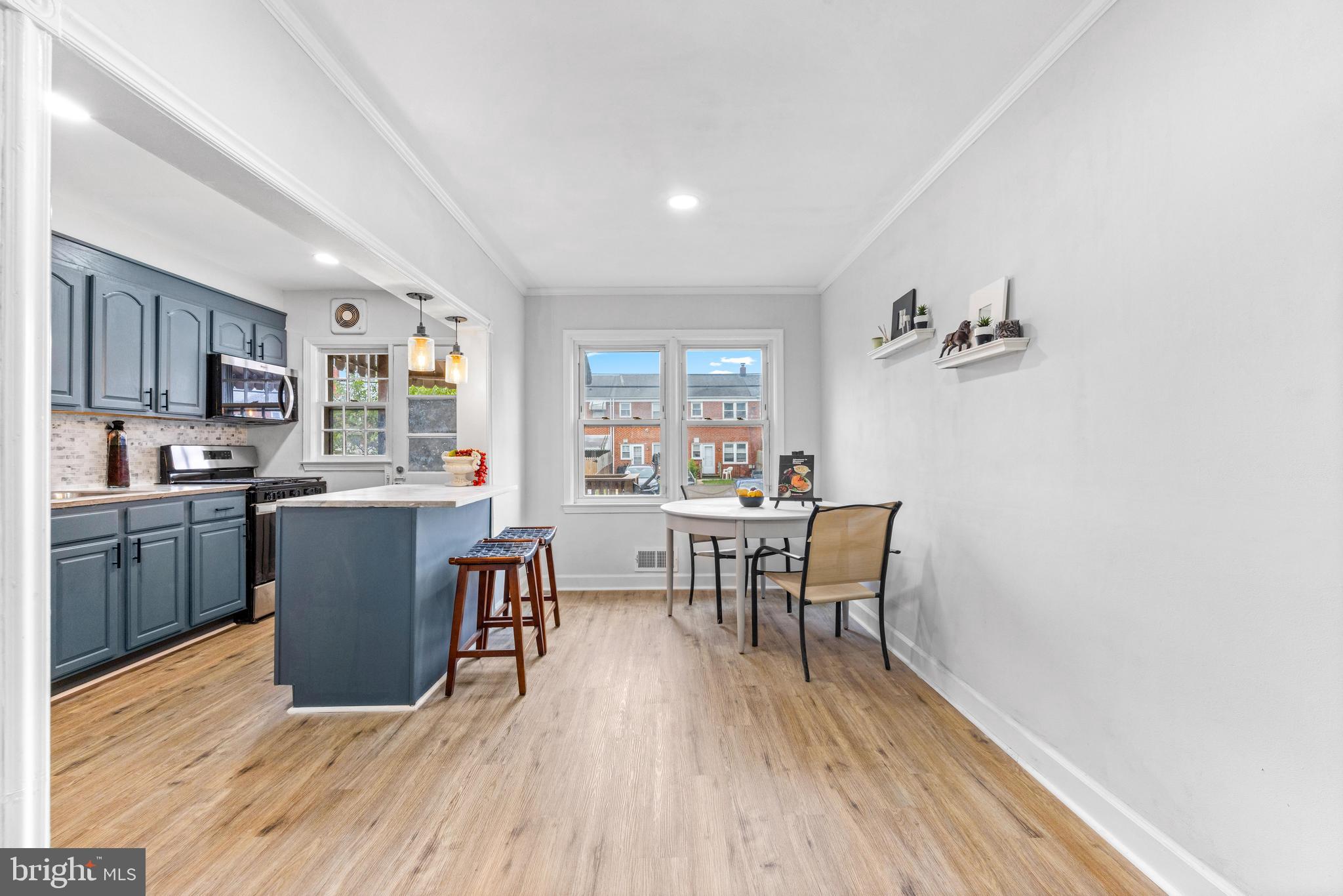 2134 Firethorn Road Middle River, MD 21220 - Photo 12 of 41 a kitchen with a table chairs refrigerator and microwave