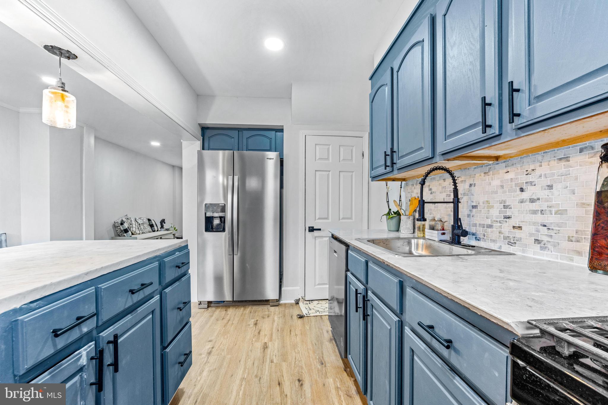 2134 Firethorn Road Middle River, MD 21220 - Photo 14 of 41 a kitchen with stainless steel appliances granite countertop a sink stove and refrigerator