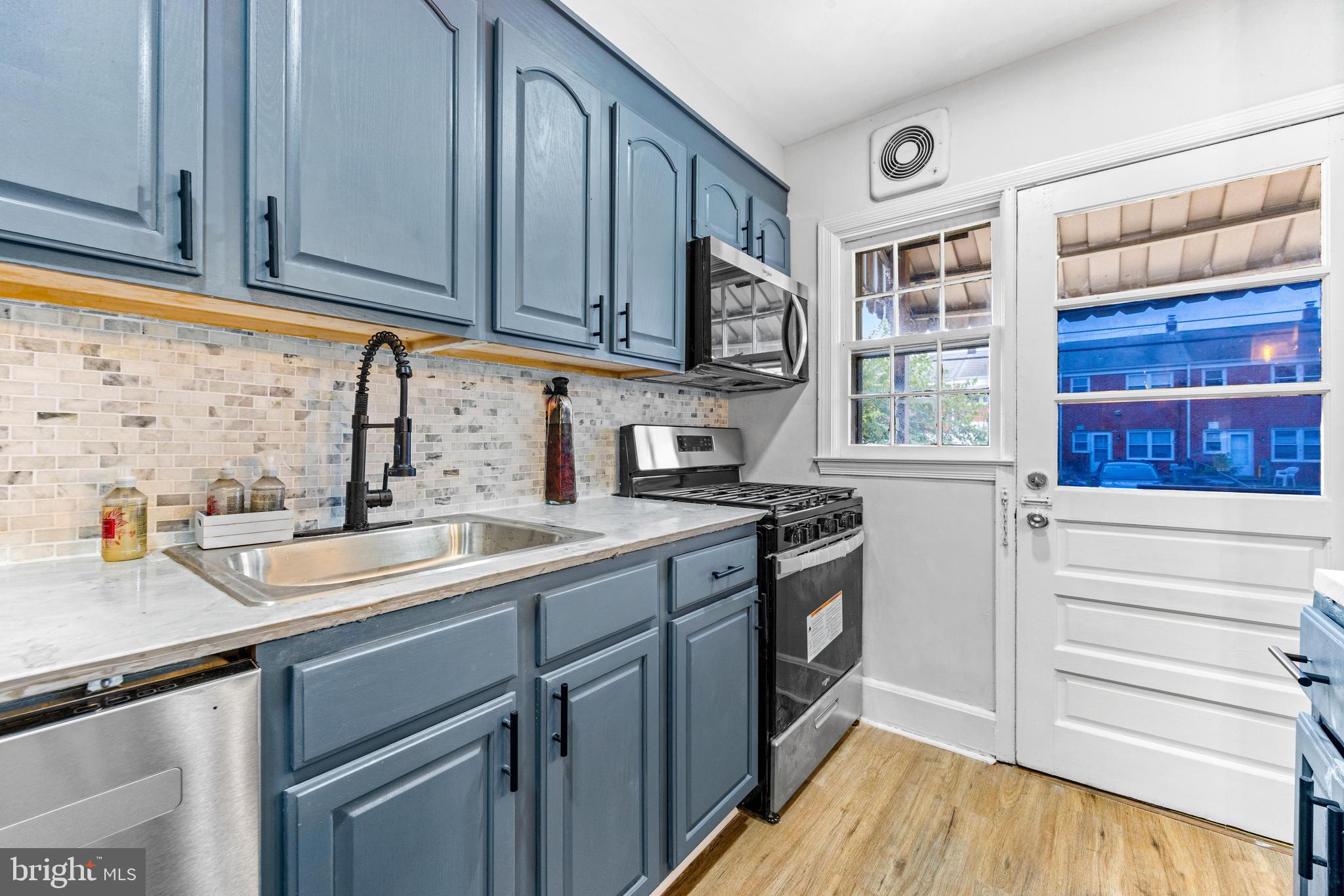 2134 Firethorn Road Middle River, MD 21220 - Photo 16 of 41 a kitchen with stainless steel appliances granite countertop a sink and a stove next to a window
