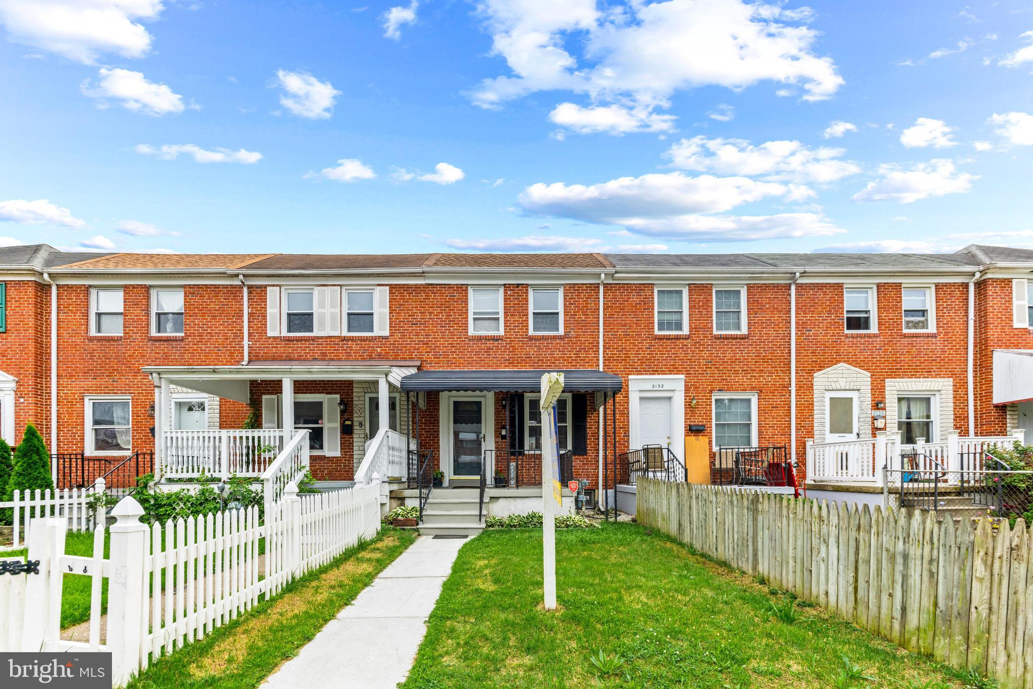 2134 Firethorn Road Middle River, MD 21220 - Photo 3 of 41 front view of a brick house with a yard and large trees