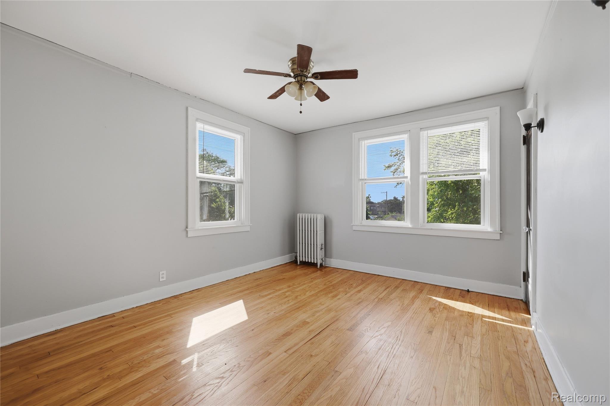 1945 Atkinson Street Detroit, MI 48206 - Photo 29 of 49 Hardwood flooring throughout, with light gray walls and white trim