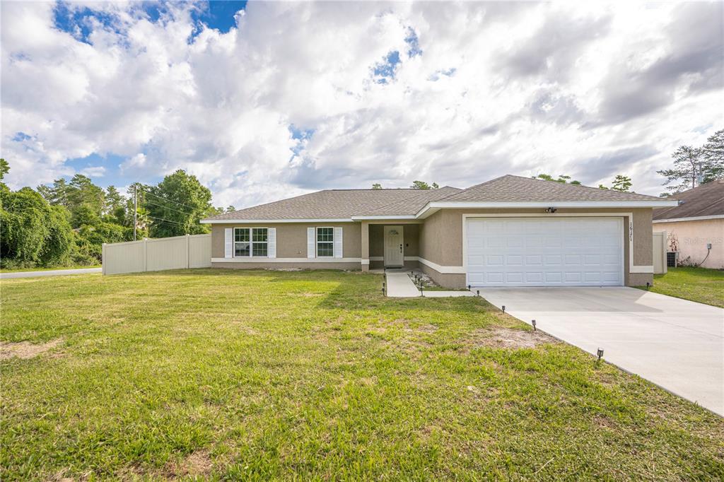 16171 Southwest 27th Terrace Road Ocala, FL 34473 - Photo 1 of 1 front view of a house with a yard
