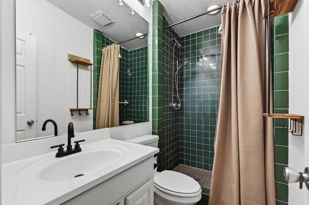 2744 Roy Sikes Road Hilliard, FL 32046 - Photo 43 of 97 a bathroom with a sink mirror toilet and shower
