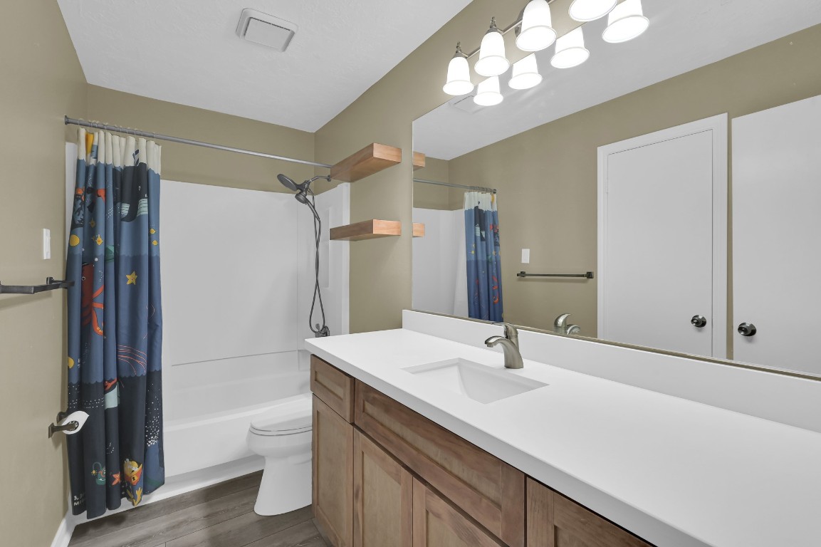 801 River Road, Unit 123F Montgomery, TX 77356 - Photo 11 of 32 a bathroom with a sink a toilet a mirror and shower