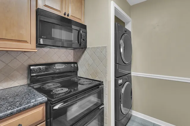 a kitchen with granite countertop cabinets and steel stainless steel appliances