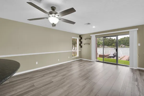 a living room with furniture and view of kitchen