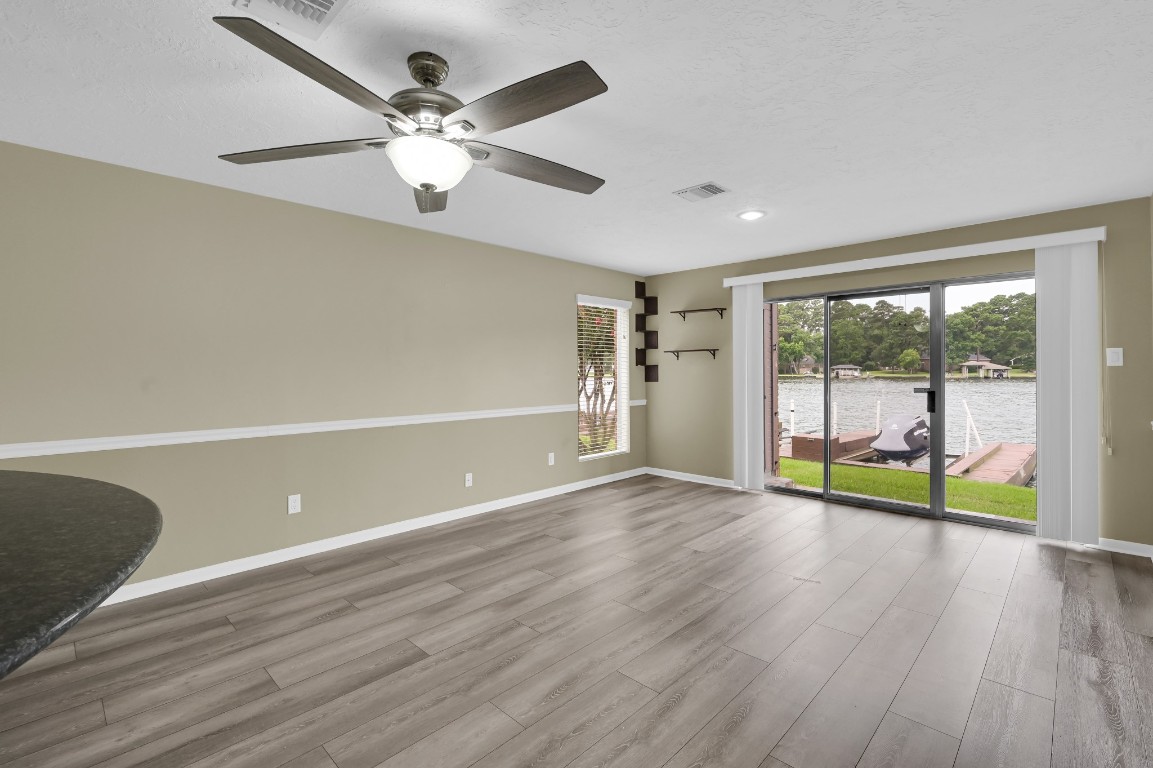801 River Road, Unit 123F Montgomery, TX 77356 - Photo 15 of 32 a view of an empty room with window and wooden floor