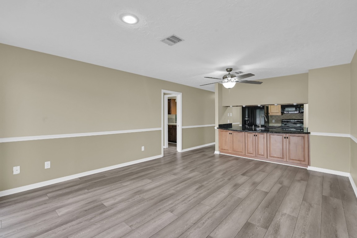 801 River Road, Unit 123F Montgomery, TX 77356 - Photo 18 of 32 a view of kitchen and empty room with wooden floor