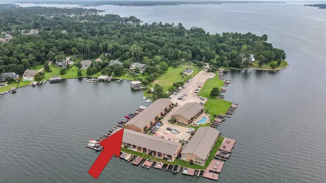 an aerial view of a house with outdoor space and lake view