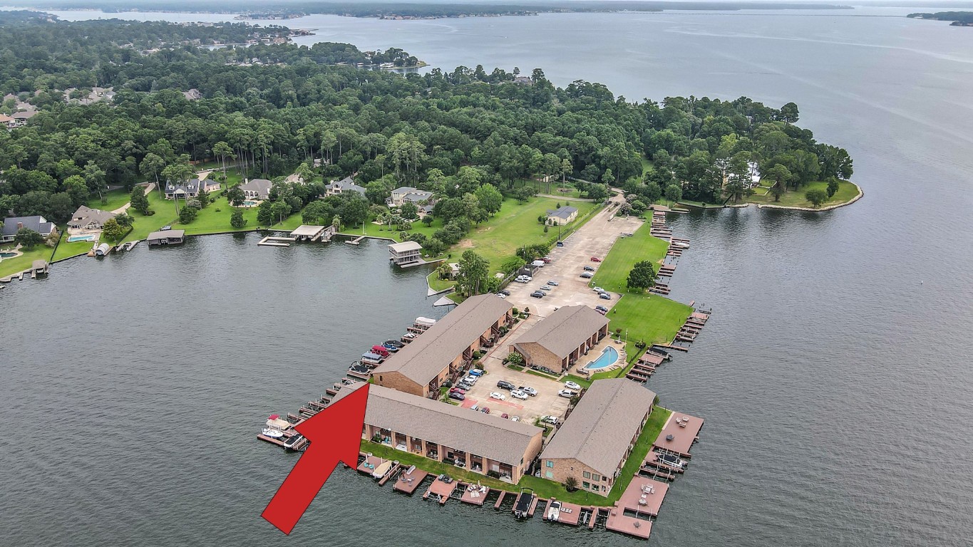 801 River Road, Unit 123F Montgomery, TX 77356 - Photo 2 of 32 an aerial view of a house with outdoor space and lake view