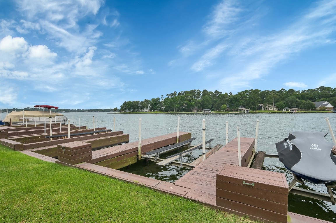 801 River Road, Unit 123F Montgomery, TX 77356 - Photo 22 of 32 a view of a lake with couches in the back yard