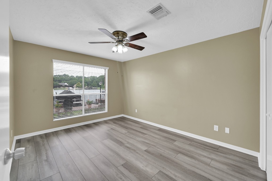 801 River Road, Unit 123F Montgomery, TX 77356 - Photo 25 of 32 a view of an empty room with wooden floor and a window
