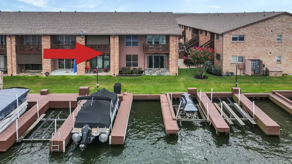 an aerial view of a house with outdoor seating