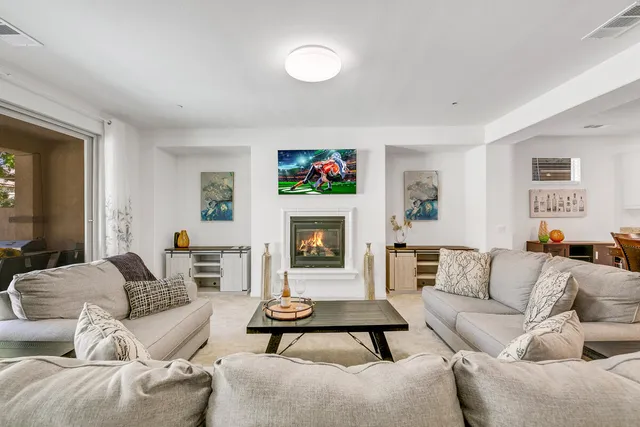 a living room with furniture a rug and a fireplace