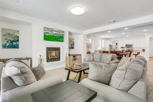 a living room with furniture kitchen and a fireplace