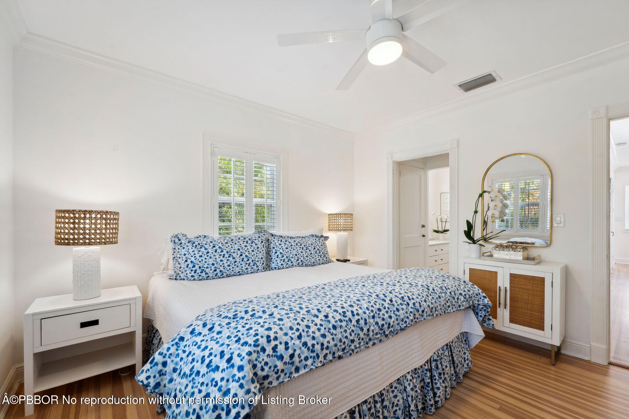 151 South County Road, Unit 2 Palm Beach, FL 33480 - Photo 11 of 22 a bedroom with a large bed and a chandelier