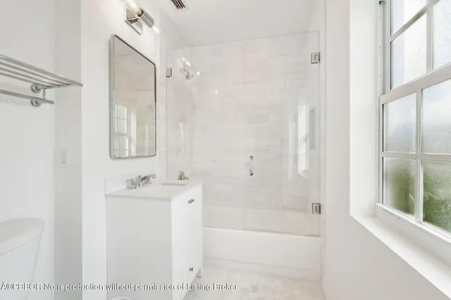 a bathroom with a bathtub a shower a sink and a mirror