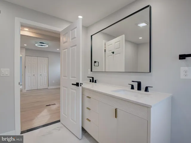 a bathroom with a double vanity sink mirror and shower