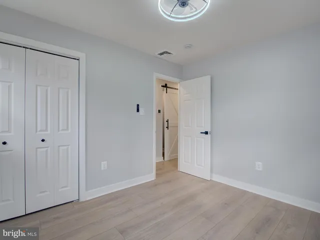 a view of a storage and utility room with wooden floor