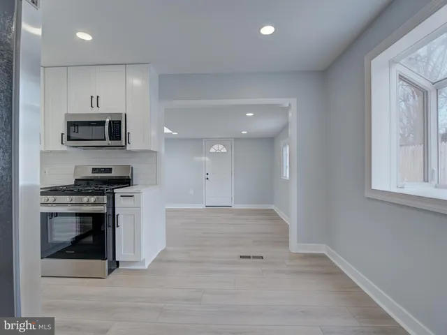 a kitchen with granite countertop a stove and a sink