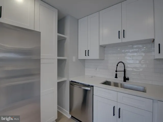 a kitchen with a sink cabinets and stainless steel appliances