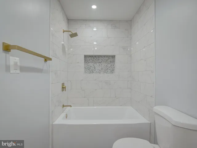 a bathroom with a bathtub and a toilet