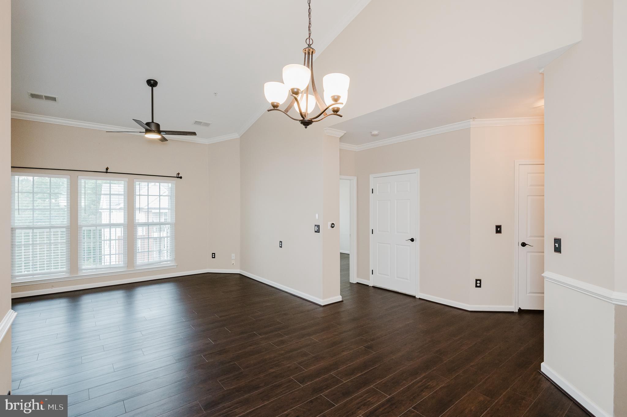 633 Wallingford Road, Unit 404 Bel Air, MD 21014 - Photo 12 of 52 a view of an empty room with wooden floor and a window