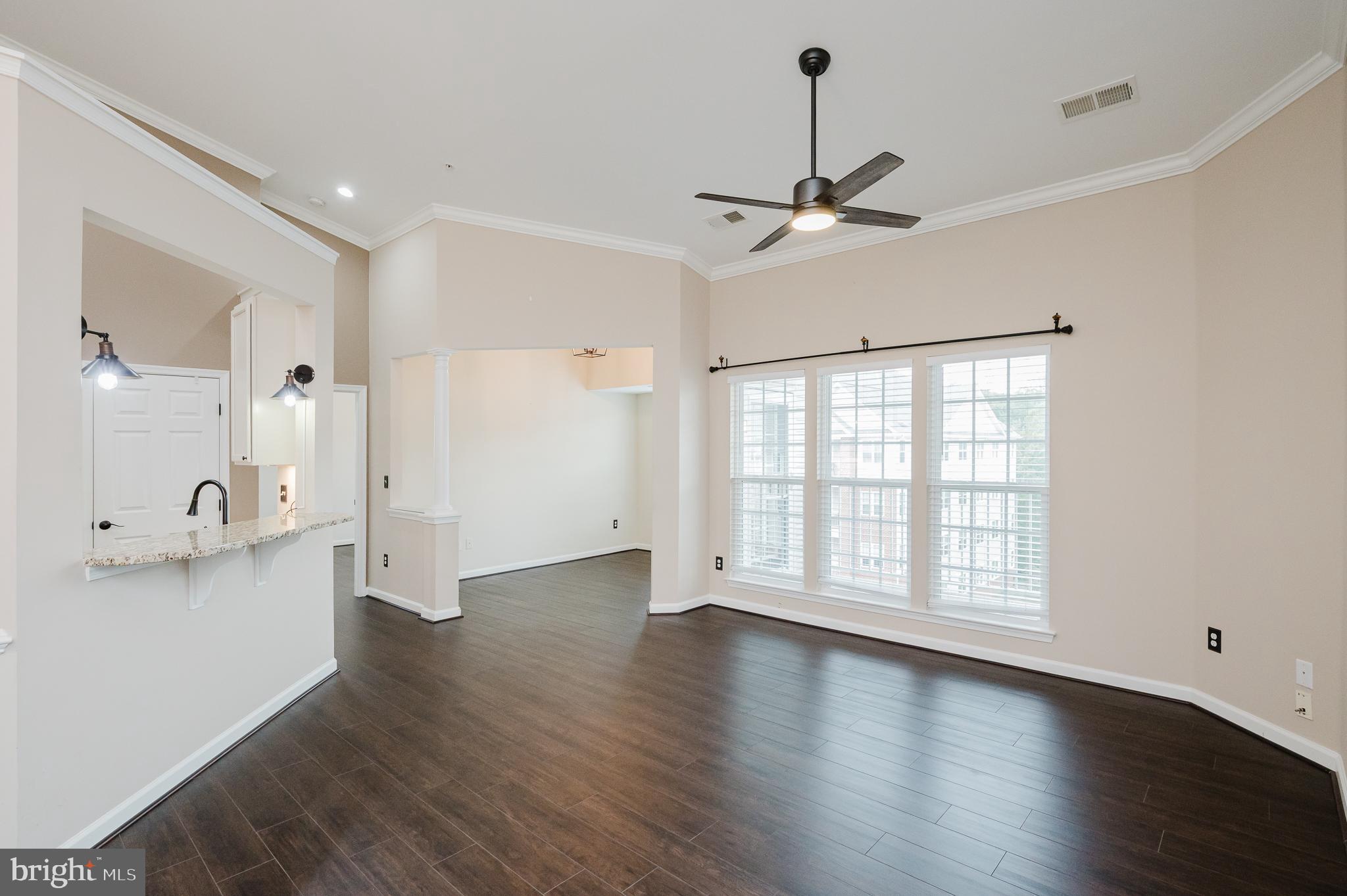 633 Wallingford Road, Unit 404 Bel Air, MD 21014 - Photo 13 of 52 a view of an empty room with a window and wooden floor