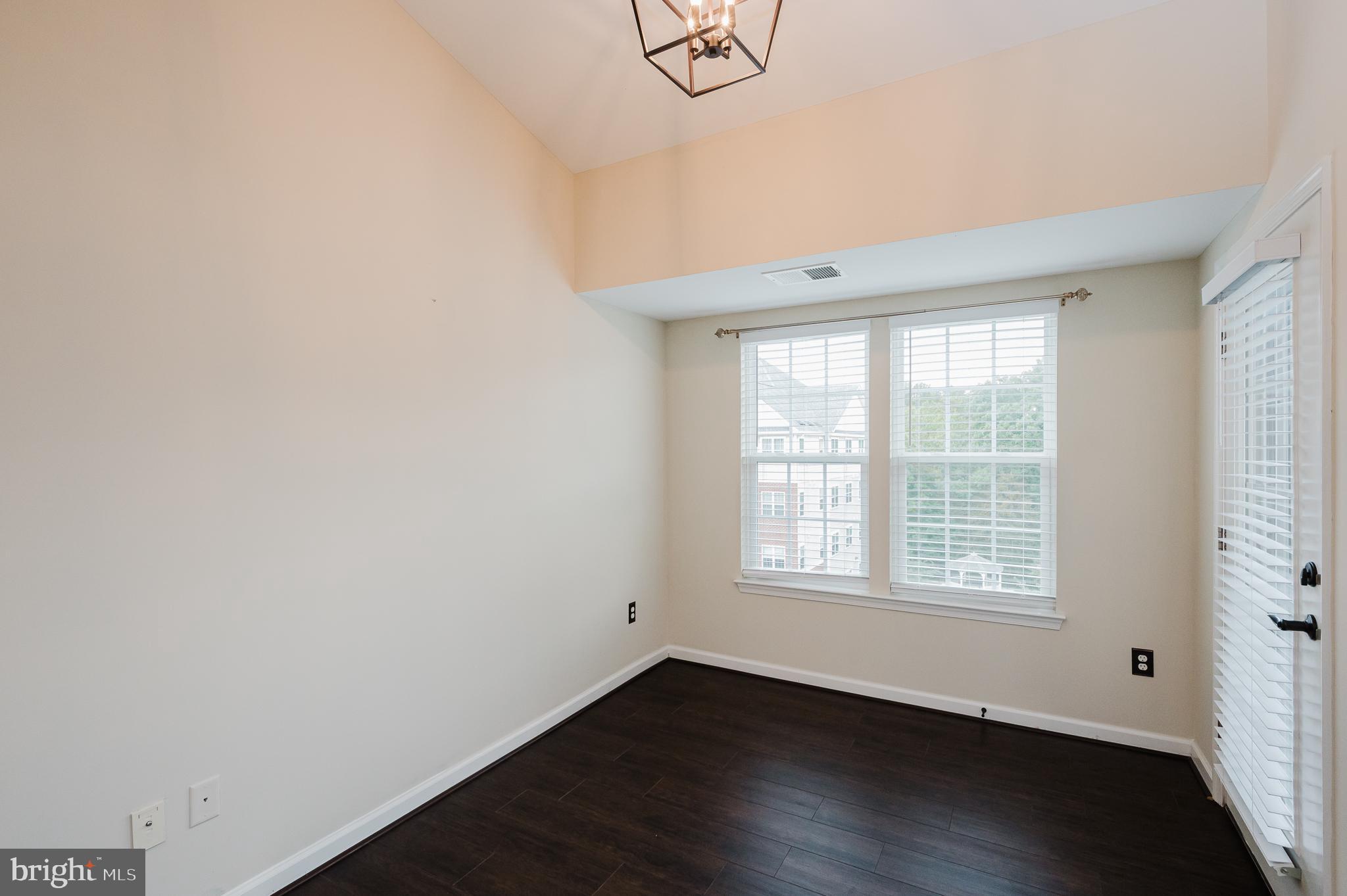 633 Wallingford Road, Unit 404 Bel Air, MD 21014 - Photo 15 of 52 an empty room with wooden floor and windows