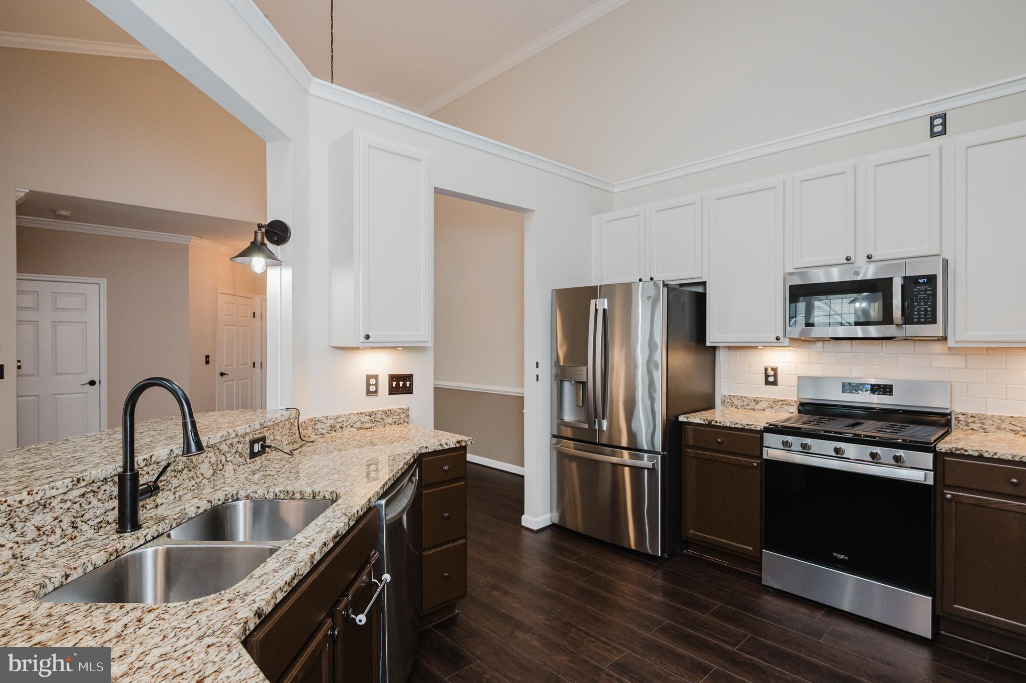 633 Wallingford Road, Unit 404 Bel Air, MD 21014 - Photo 17 of 52 a kitchen with kitchen island stainless steel appliances a sink stove and refrigerator