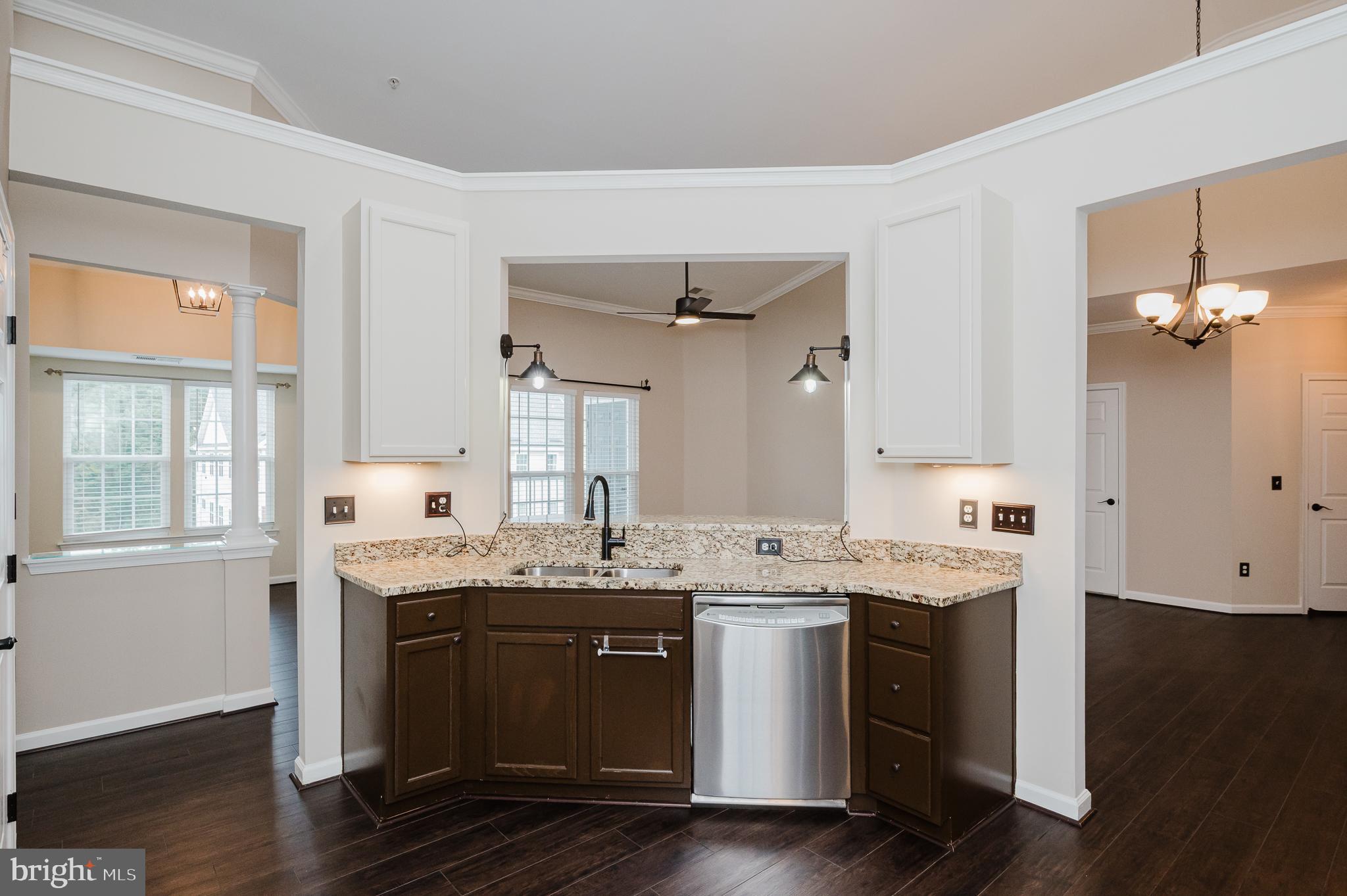 633 Wallingford Road, Unit 404 Bel Air, MD 21014 - Photo 18 of 52 a view of a kitchen with granite countertop a sink and dishwasher with wooden floor