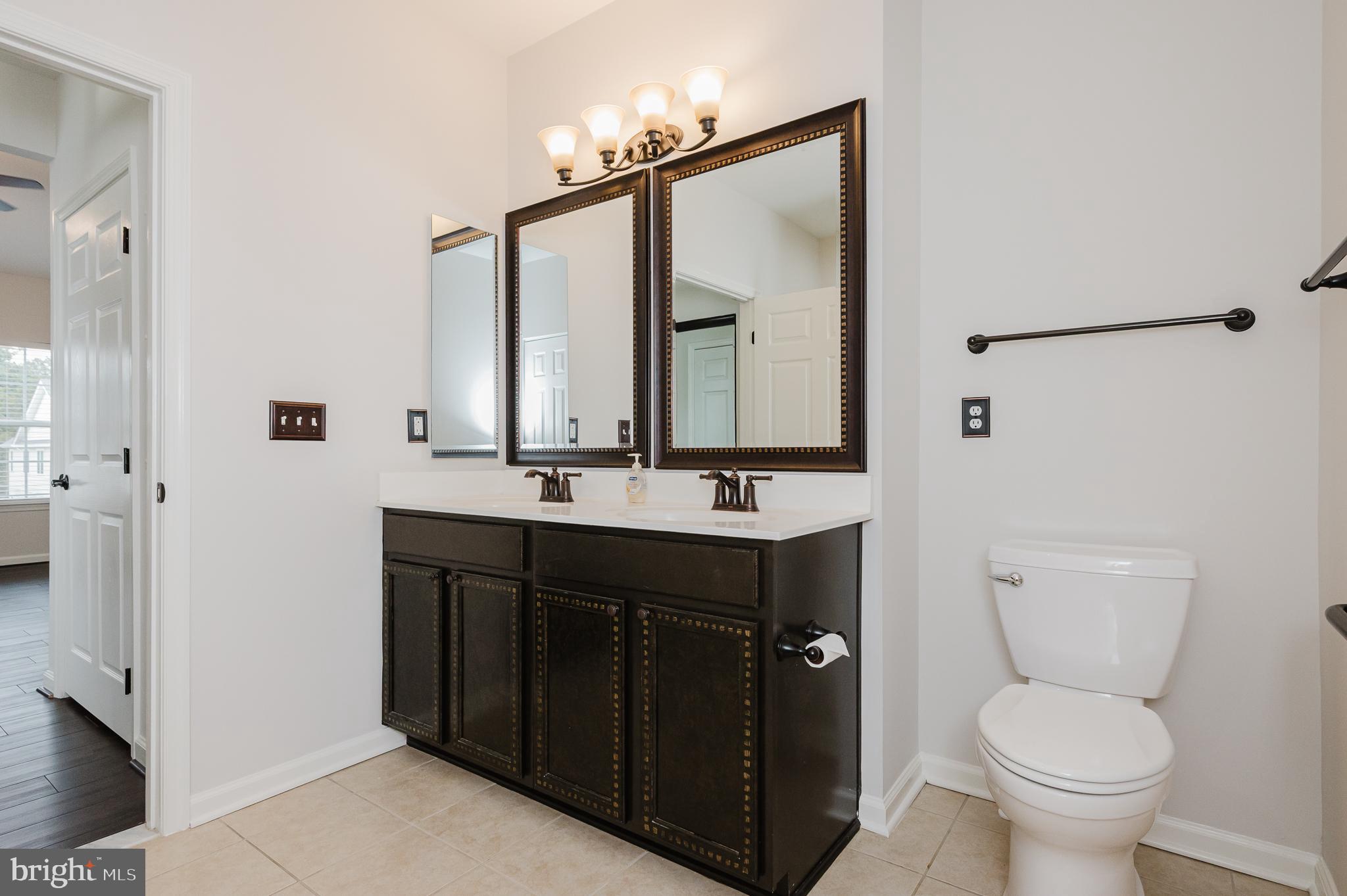 633 Wallingford Road, Unit 404 Bel Air, MD 21014 - Photo 27 of 52 a bathroom with a toilet sink and mirror