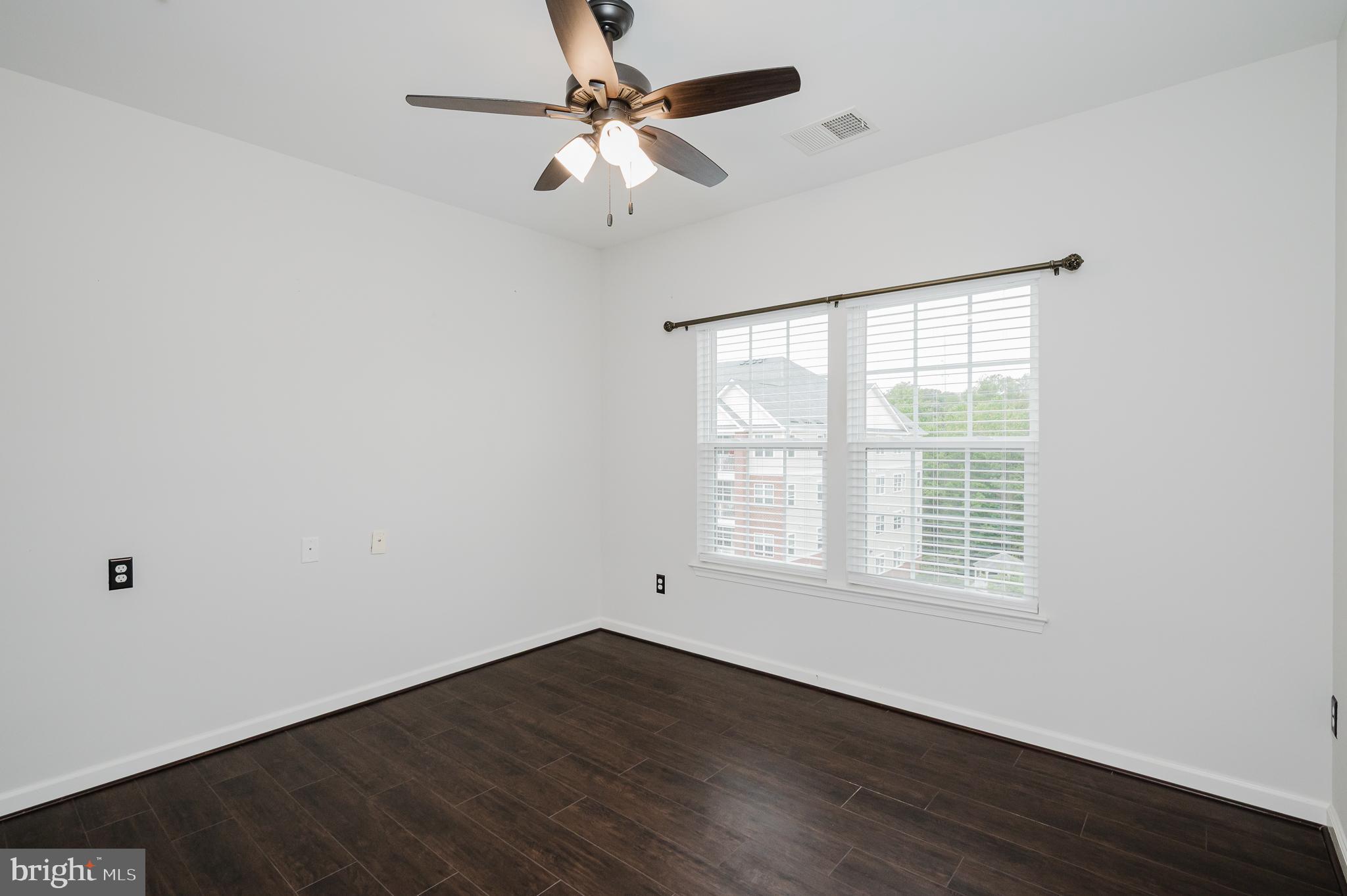 633 Wallingford Road, Unit 404 Bel Air, MD 21014 - Photo 29 of 52 an empty room with wooden floor fan and windows