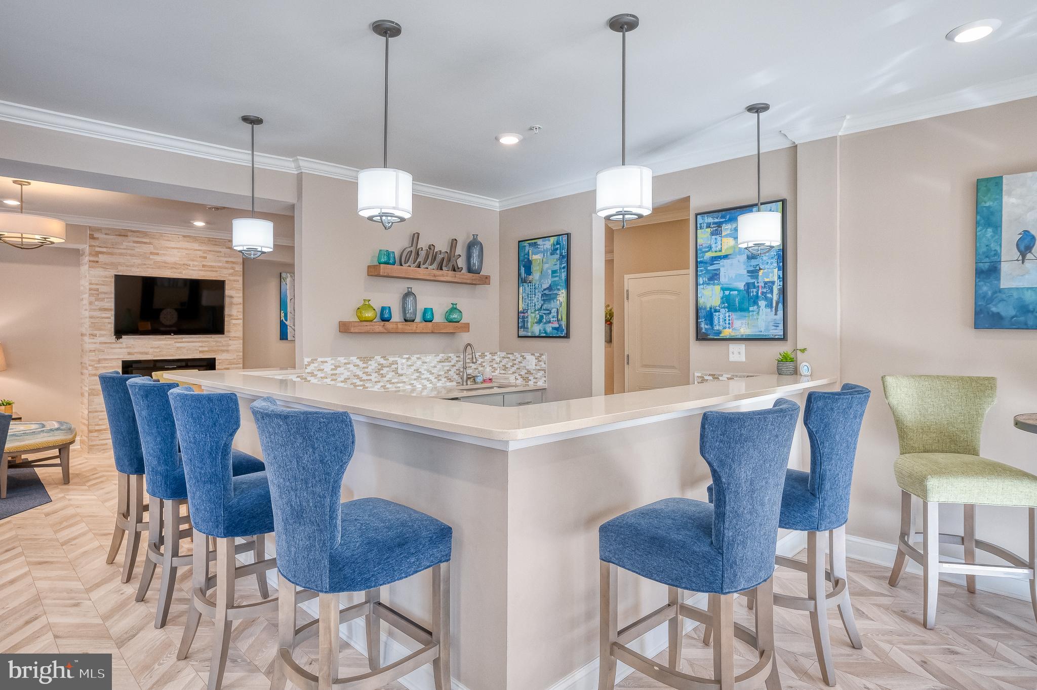 633 Wallingford Road, Unit 404 Bel Air, MD 21014 - Photo 45 of 52 a kitchen with a dining table chairs sink and white cabinets