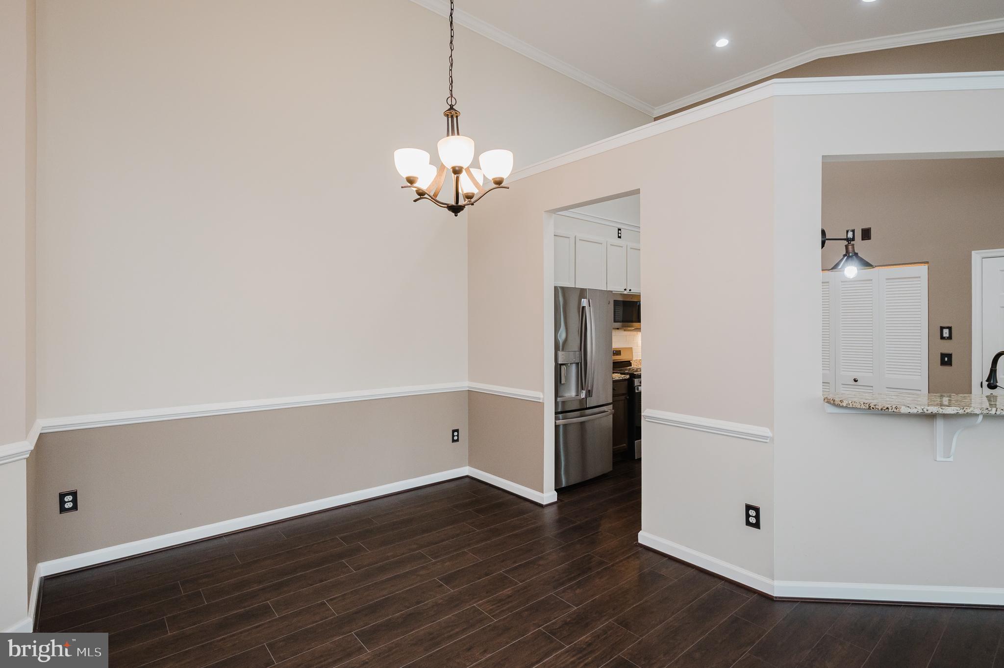 633 Wallingford Road, Unit 404 Bel Air, MD 21014 - Photo 9 of 52 a view of a kitchen with wooden floor and a ceiling fan