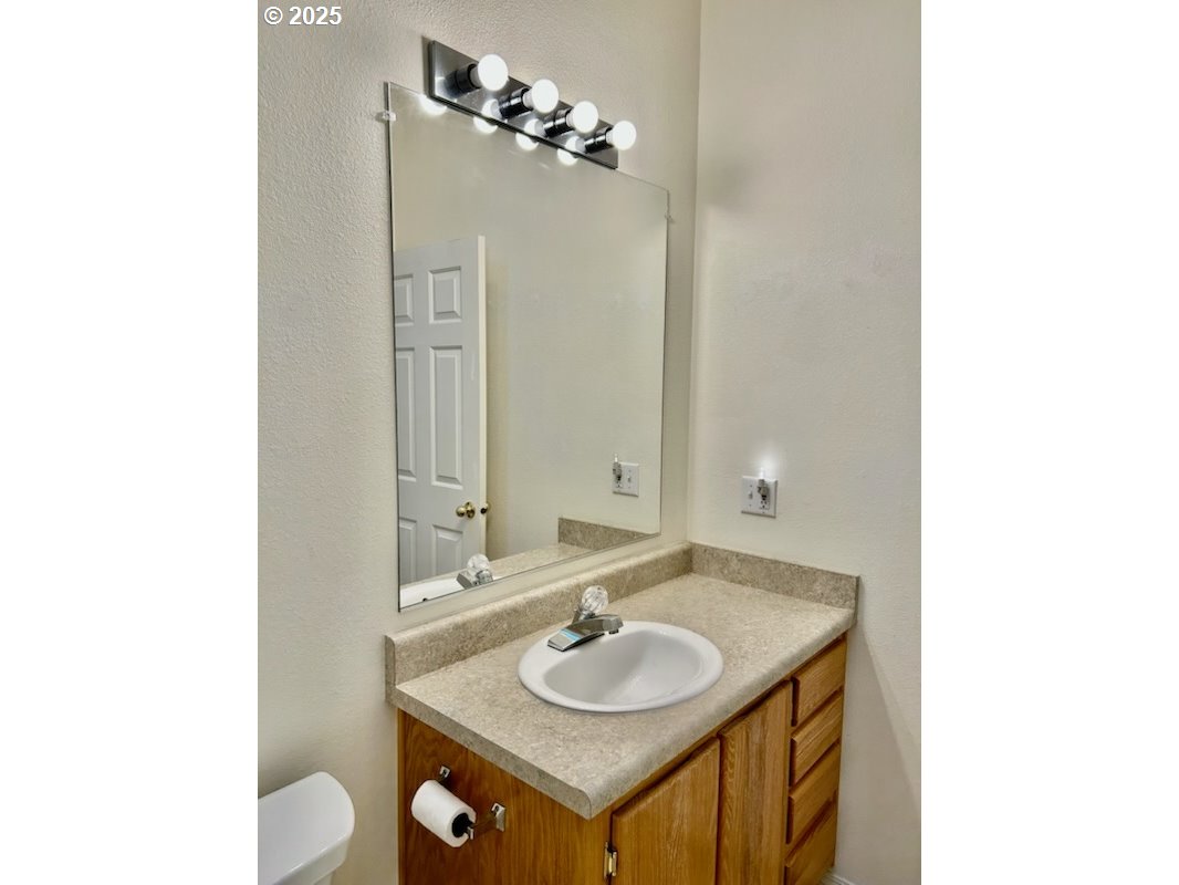 402 Sherwood Loop Florence, OR 97439 - Photo 16 of 33 a bathroom with a sink and a mirror