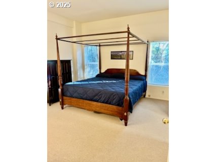 402 Sherwood Loop Florence, OR 97439 - Photo 18 of 33 a bedroom with a bed and a ceiling fan