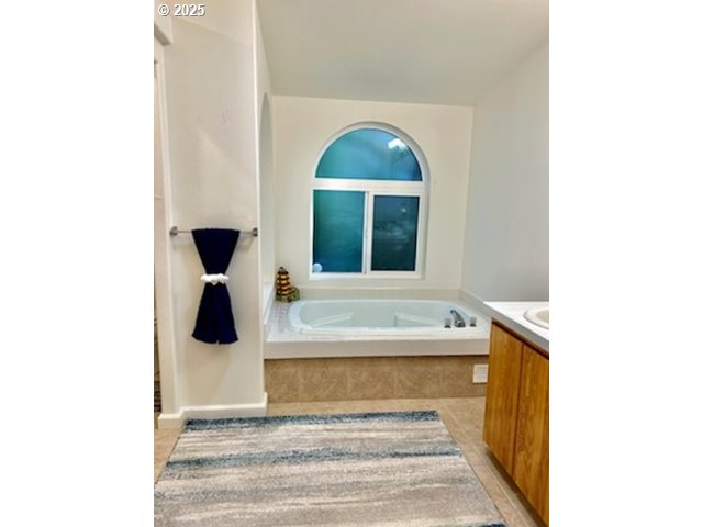 402 Sherwood Loop Florence, OR 97439 - Photo 20 of 33 a view of a bathroom with a bathtub and a window