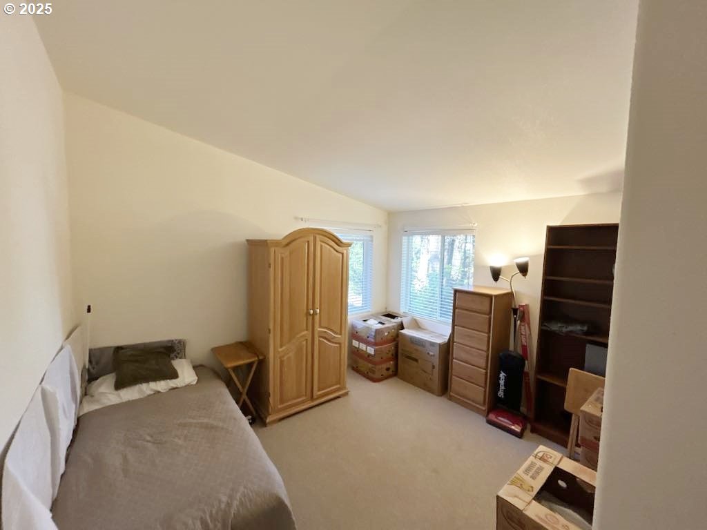 402 Sherwood Loop Florence, OR 97439 - Photo 24 of 33 a bedroom with furniture and a refrigerator