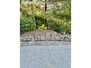 402 Sherwood Loop Florence, OR 97439 - Photo 26 of 33 a view of a yard with plants and brick wall