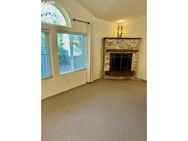 402 Sherwood Loop Florence, OR 97439 - Photo 8 of 33 a view of an empty room with a fireplace and a window