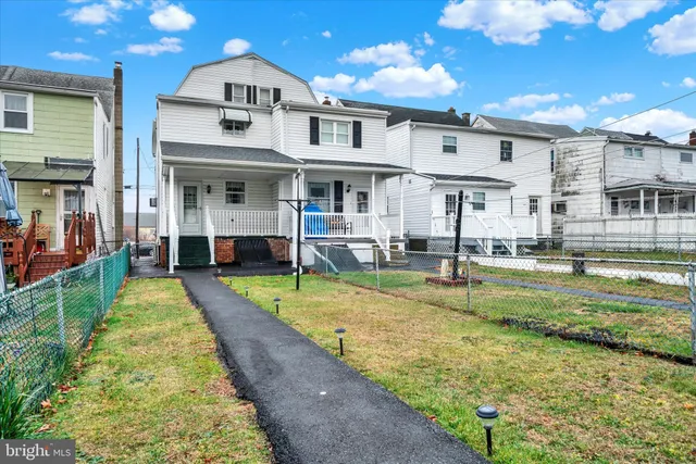 a view of an house with swimming pool and sitting area