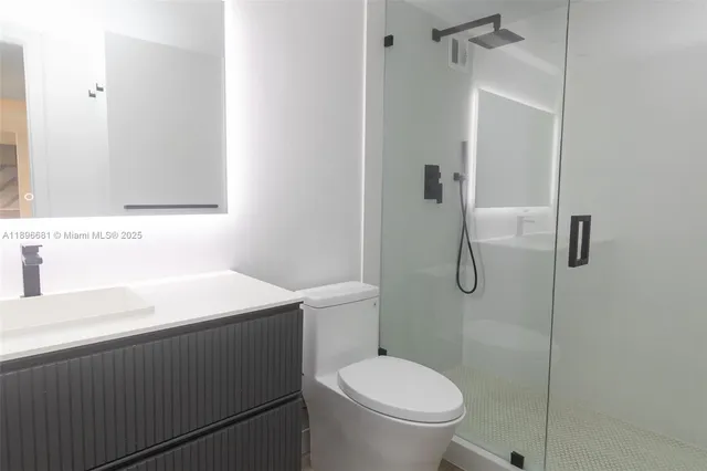 a bathroom with a sink toilet and shower