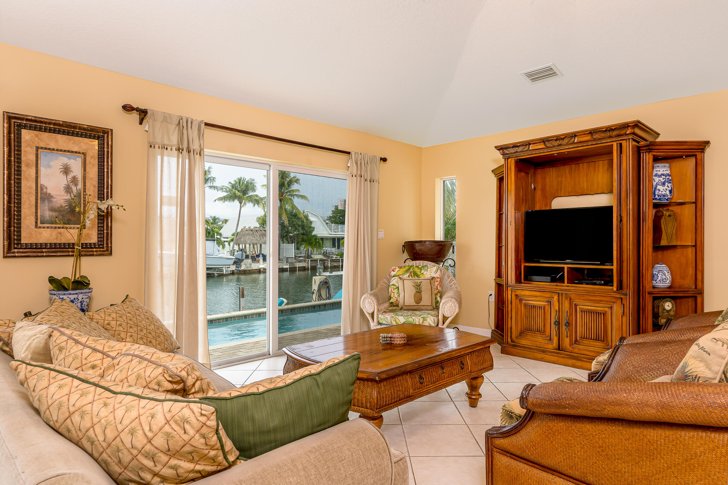 260 Sadowski Causeway Key Colony Beach, FL 33051 - Photo 2 of 50 a living room with furniture and a flat screen tv