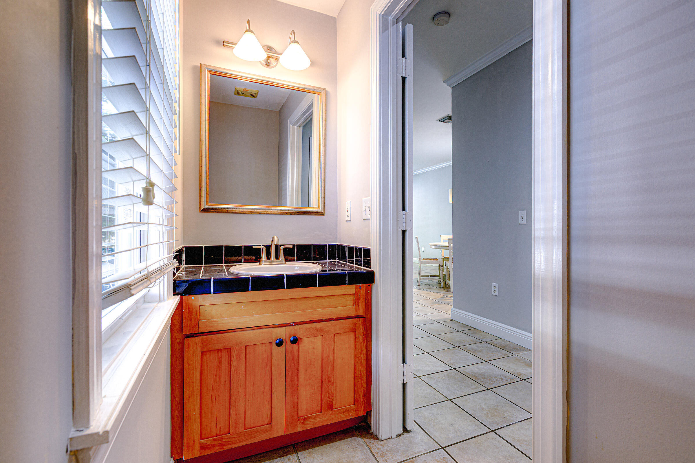 263 Golf Club Drive Key West, FL 33040 - Photo 3 of 30 a bathroom with a sink a toilet and mirror