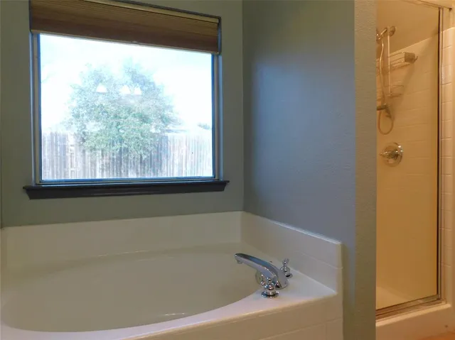 a bathroom with a bathtub and window