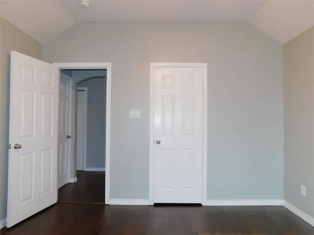 an empty room with wooden floor